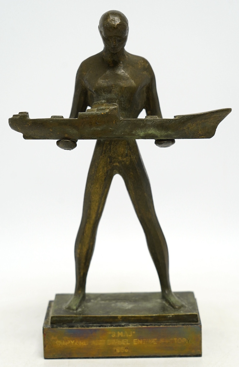 A 1960s modernist bronze figure of a man holding a boat, plaque inscribed ‘“3.MAJ” SHIPYARD AND DIESEL ENGINE FACTORY 1968.’, 29cm. Condition - fair to good